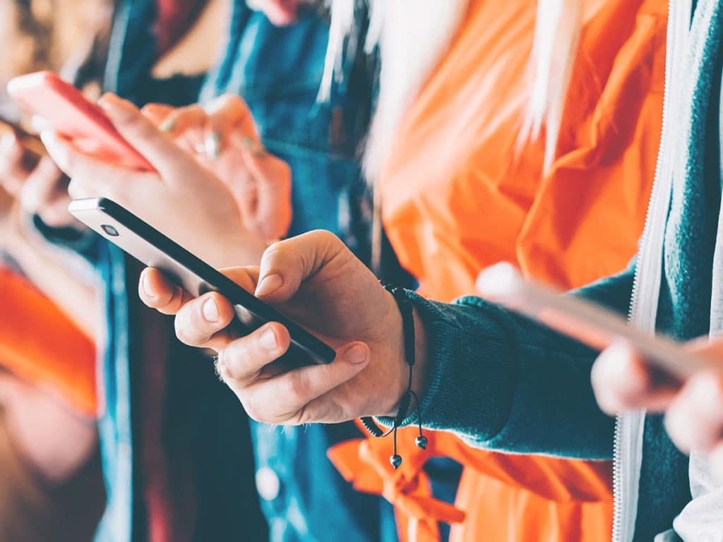 Close-up photo of a person using a smartphone.